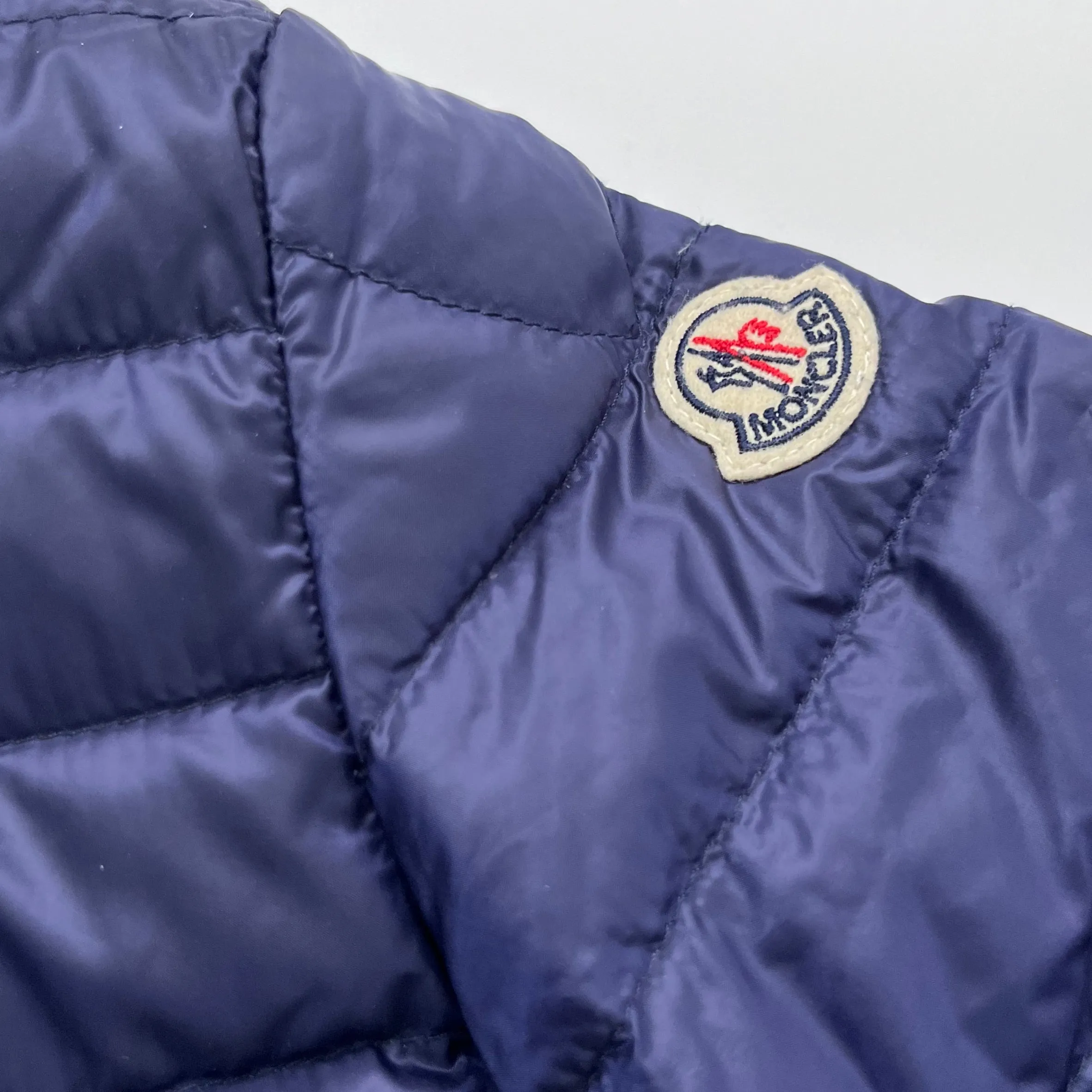 Moncler Navy Blue Down Filled Collarless Jacket: 4 Years